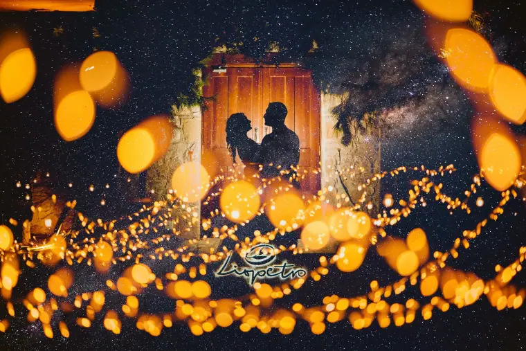 Silhouette of Lucin and Sal in a stone doorway under a starry sky and glowing lights at Liopetro, Kouklia