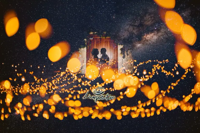 Couple silhouetted in a stone doorway under the Milky Way with glowing bokeh lights, Liopetro, Kouklia