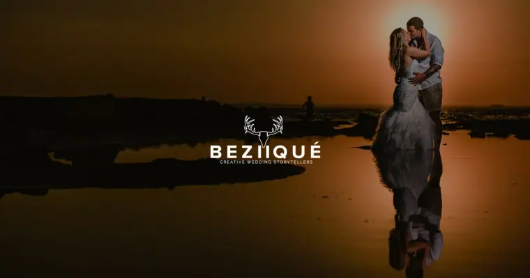 Beziique logo over a couple reflected in still water at sunset