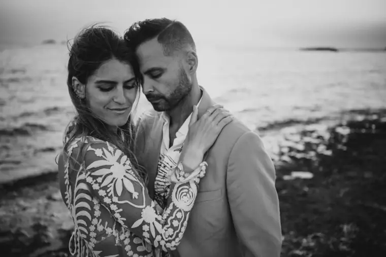 Black-and-white portrait of Kenton and Hassiba cheek to cheek by the sea, Ibiza