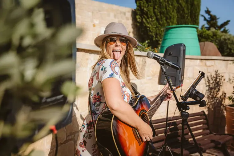 Aimie Wild singing and playing acoustic guitar at a wedding reception, Aphrodite Hills, Paphos