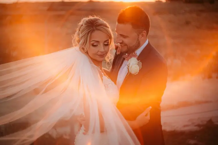 Katie and Lee at golden hour, her veil blowing across them, Liopetro, Kouklia