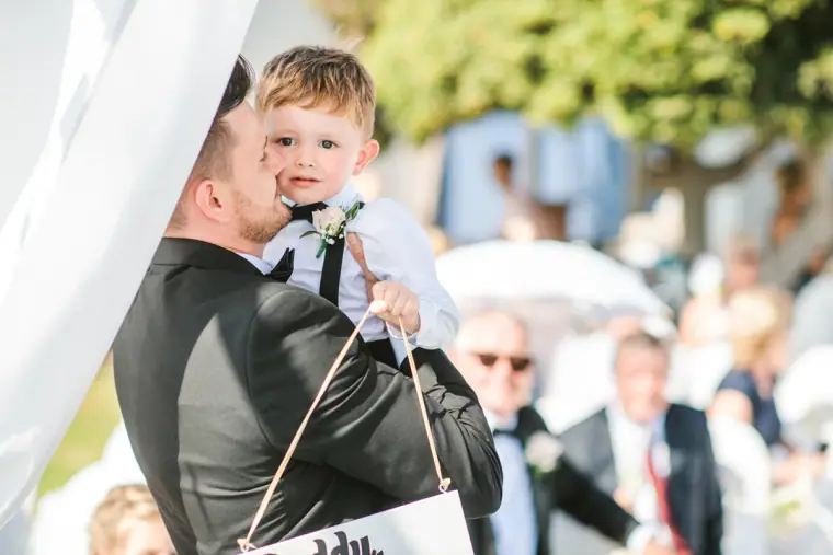 Steven hugging the page boy at the ceremony canopy