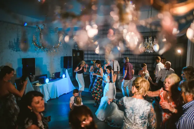 Guests dancing beneath chandeliers and party lights at the evening reception, Almyra