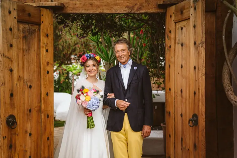 Antonia with her father in the wooden doorway before walking down the aisle