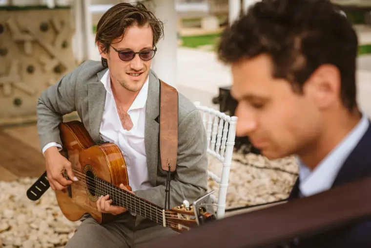 Guitarist in sunglasses playing for guests at the ceremony at Atzaro, Ibiza