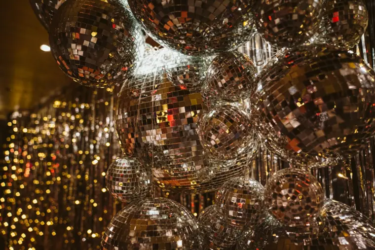 Cluster of mirrored disco balls sparkling above the dance floor