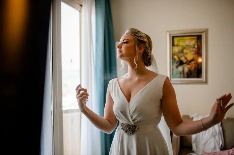 Francesca turning by the window in her V-neck dress and jewelled belt