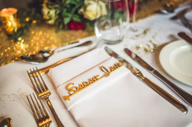 Place setting with Sarah Jane in gold lettering on a white napkin