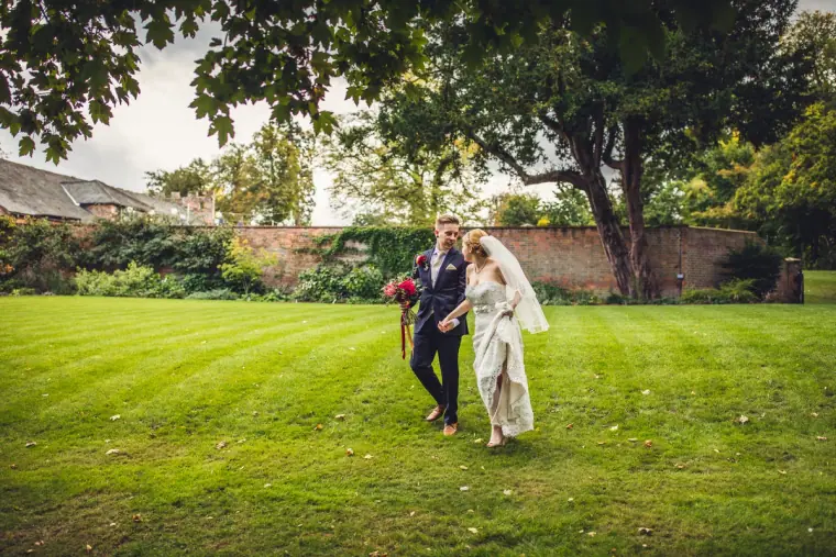 Sarah and Charlie walking across the lawn of the walled garden, Wasing Park
