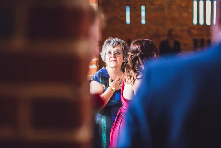 Guests applauding as the couple enter the barn reception