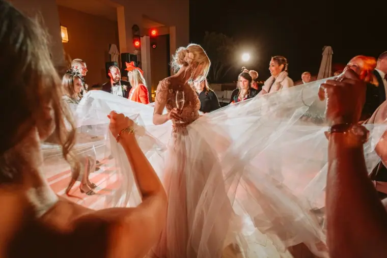 Lena dancing with guests as her long veil swirls at Elea, Paphos