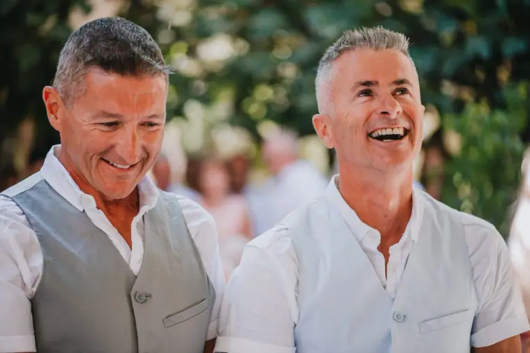 Andy and Andrew laughing together in white shirts and waistcoats