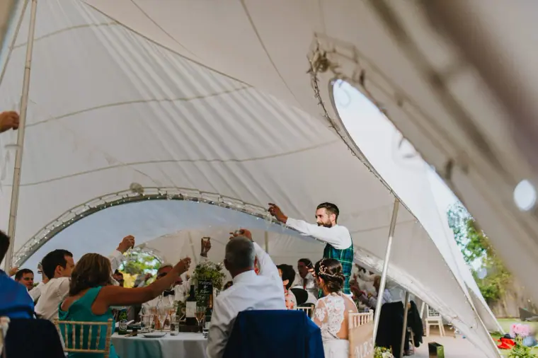 Guest giving a speech in a white stretch-tent marquee in Windsor, Berkshire