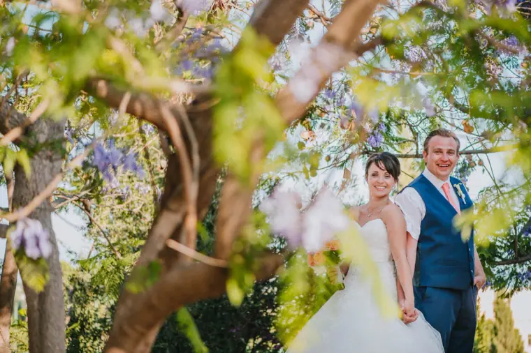 Natasha and Joey under a jacaranda tree in bloom at Aphrodite Hills, Paphos
