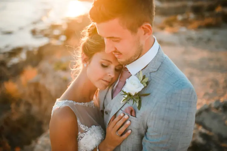 Naomi resting her head on Dale's chest in warm sunset light, Nissi Beach Resort