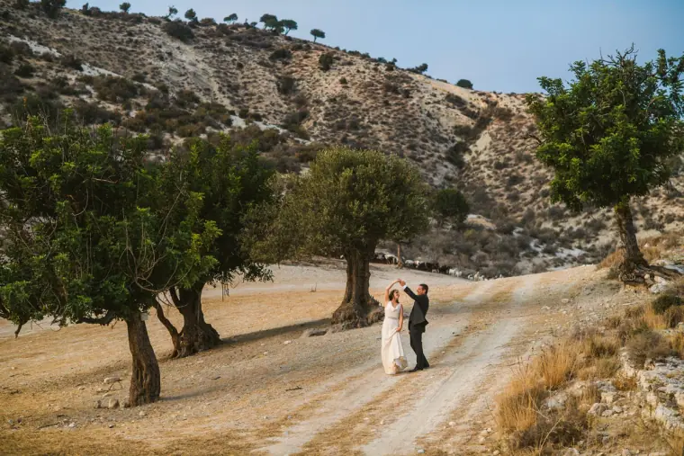 Kazem and Fleur on a dusty track among olive trees and scrubby hills, Vasilias Nikoklis Inn