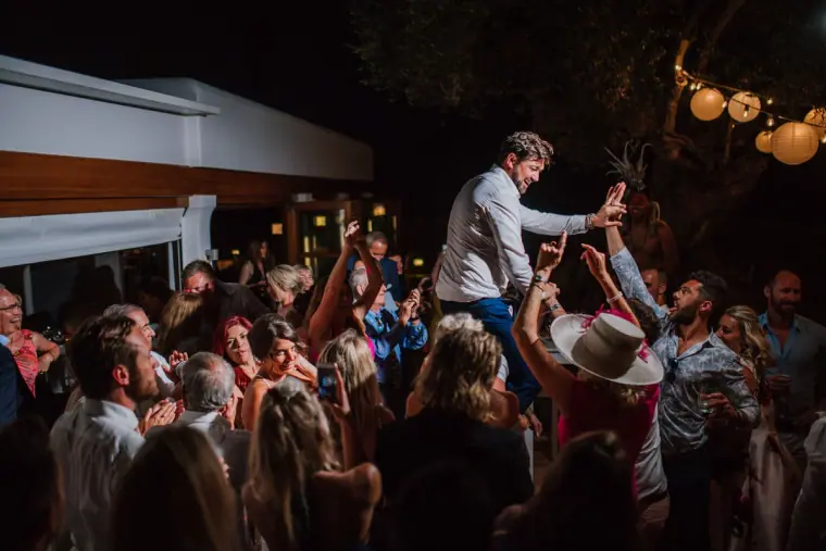 Guest held aloft by the crowd at a lively night-time party at Can Curreu, Ibiza