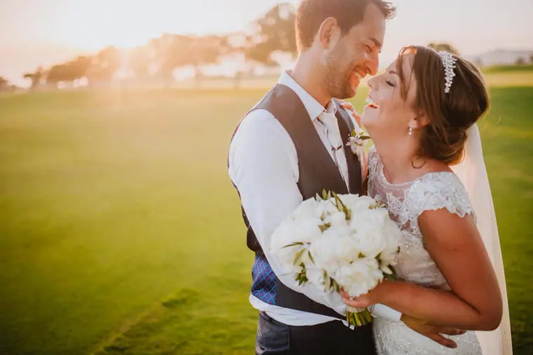 Aaron and Danielle nose to nose on a sunlit lawn at Elea Estate, Paphos