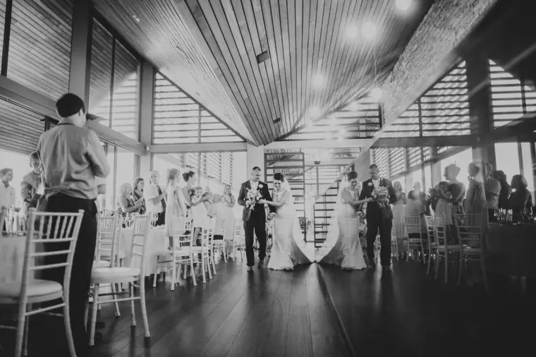 Black-and-white photo of the first dance in a timber-roofed venue at Minthis Hills, Paphos