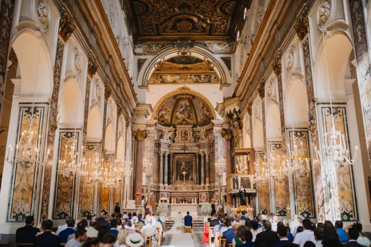 Ceremony inside a gilded baroque cathedral filled with guests on the Amalfi Coast