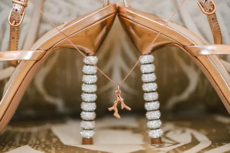 Rose-gold bridal heels with diamanté-studded heels hanging side by side, Anassa