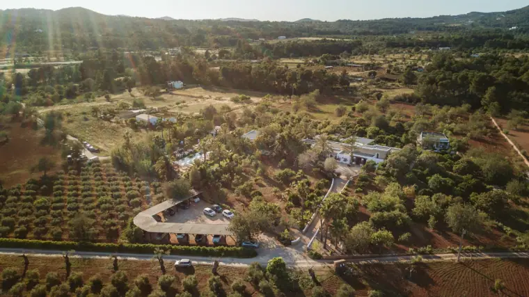 Aerial view of Agroturismo Can Gall among orchards and green hills in Ibiza