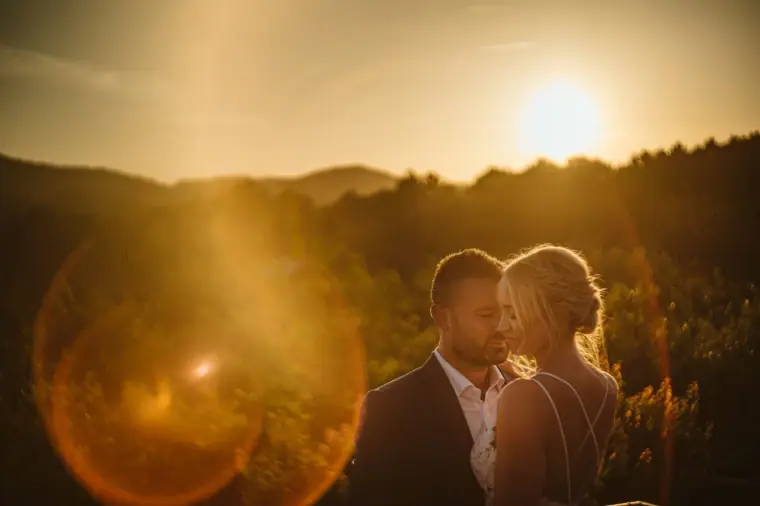 Sophie and Iain cheek to cheek in golden sunset light over the Ibizan hills at Can Gall