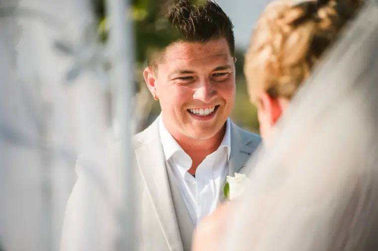Nathan beaming at Charlotte during their ceremony at Coral Beach Hotel