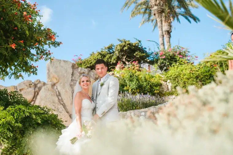 Charlotte and Nathan among palm trees and bougainvillea in the Coral Beach Hotel gardens