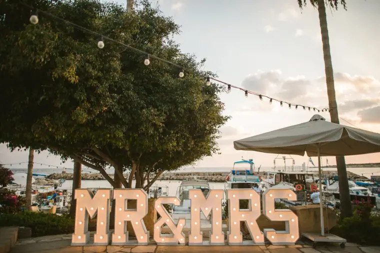 Light-up Mr & Mrs letters by the harbour at Coral Beach Hotel, Paphos, at dusk
