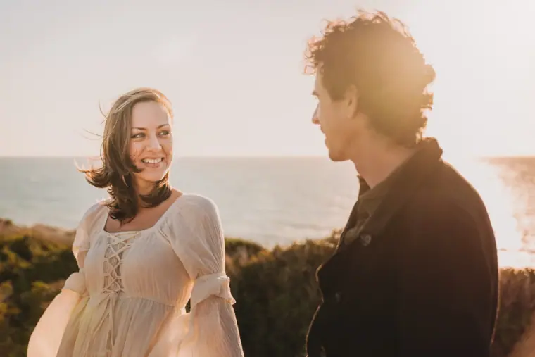 Aiko smiling at Erez in golden light on the cliffs above the sea, Paphos