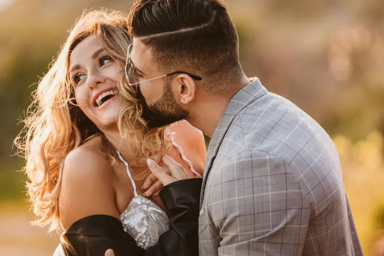 Close-up of a laughing bride being kissed on the cheek by her groom, Kouklia