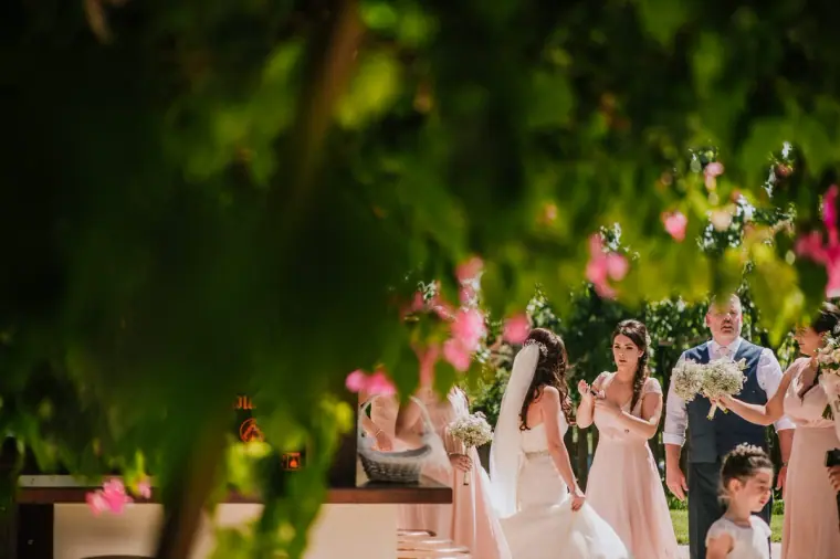 Bridesmaids and flower girls waiting to walk down the aisle in the garden