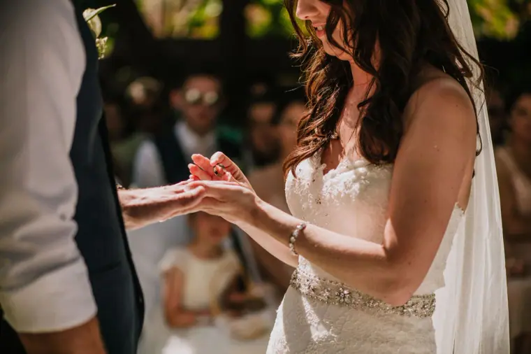 Close-up of Claire placing the ring on Sean's finger