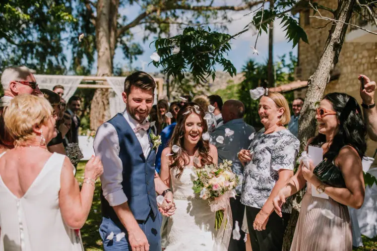 Guests greeting Claire and Sean with hugs after the ceremony