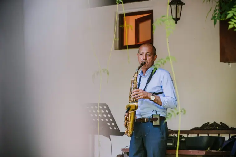 Saxophonist playing for guests during the drinks reception in the courtyard