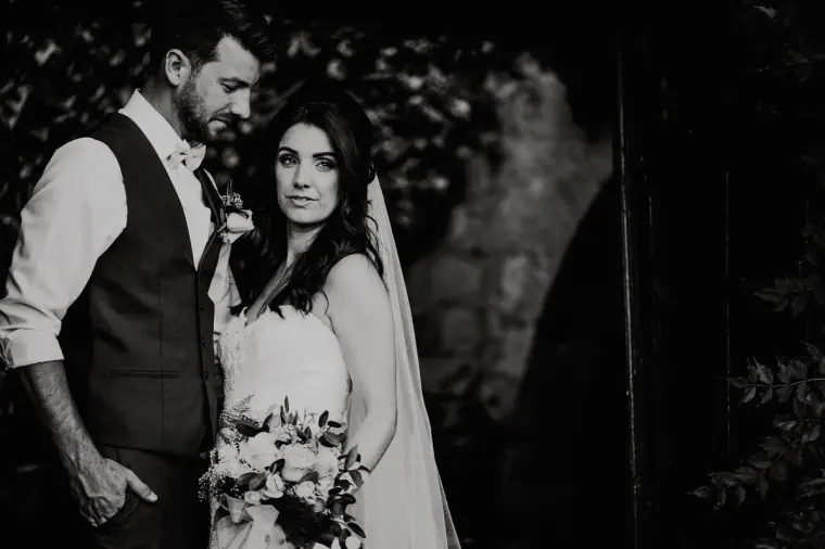 Black-and-white portrait of Claire and Sean in a dark doorway
