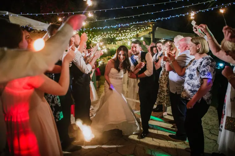 Guests holding up sparklers around Claire and Sean's first dance