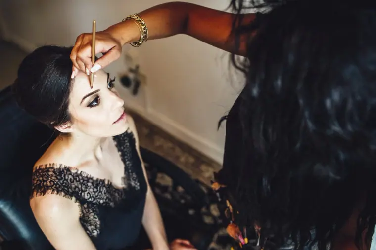 Make-up artist applying eyeliner to Ruby