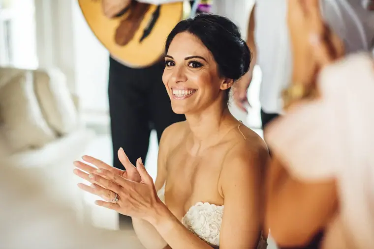 Ruby smiling and clapping along to the musicians