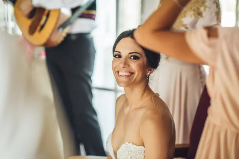 Ruby smiling up at bridesmaids as the lute player plays behind her