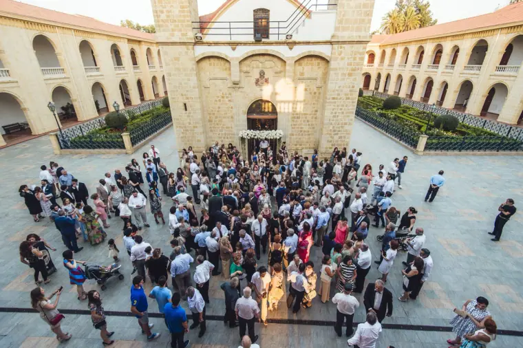 Overhead view of guests gathering in the arcaded monastery courtyard in Nicosia