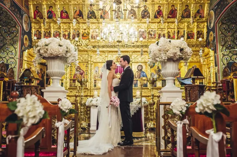 Ruby and Angelos at the gilded iconostasis amid white hydrangea arrangements, Nicosia