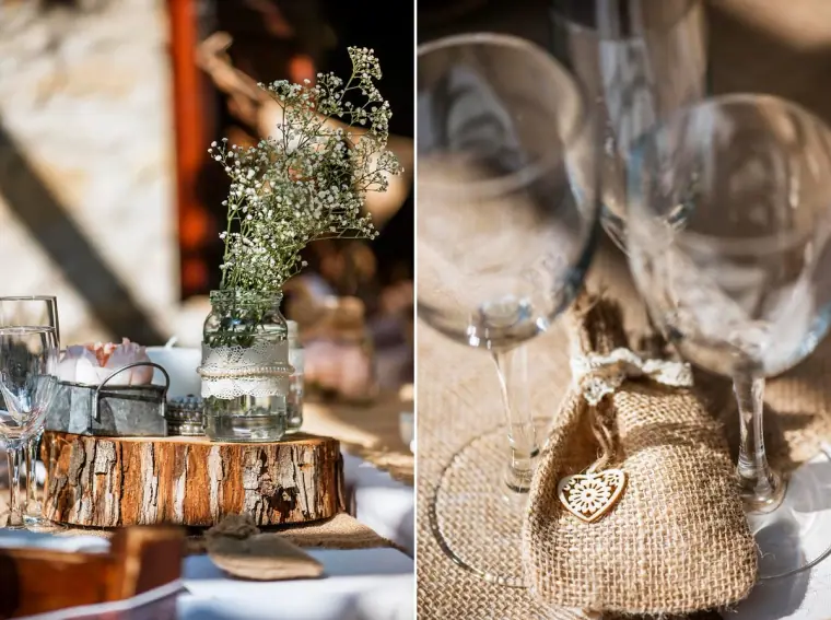 Rustic table details: gypsophila in a jar on a log slice and a hessian favour bag by wine glasses