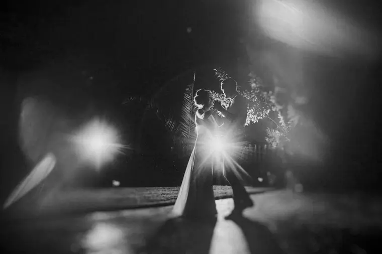 Black-and-white photo of the first dance with starburst lights behind the couple