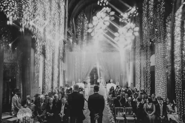 Black-and-white photo of guests seated beneath cascading lights in Mansfield Traquair