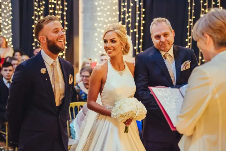 Leonnie smiling at Andy as the celebrant opens the ceremony