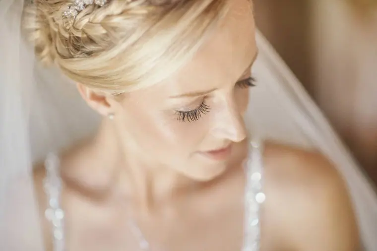 Soft close-up of the bride's braided hair and beaded bodice