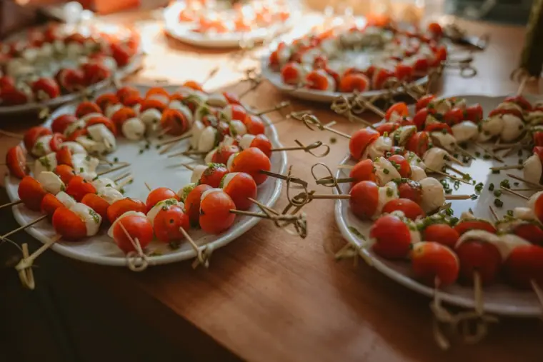 Platters of tomato and mozzarella canapés on skewers at the drinks reception